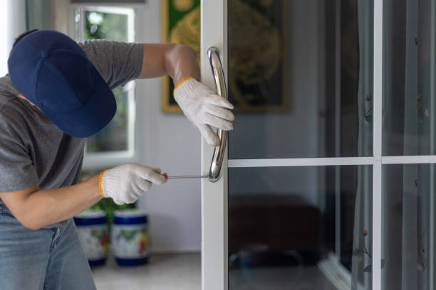 Worker install handle on aluminium swing door.