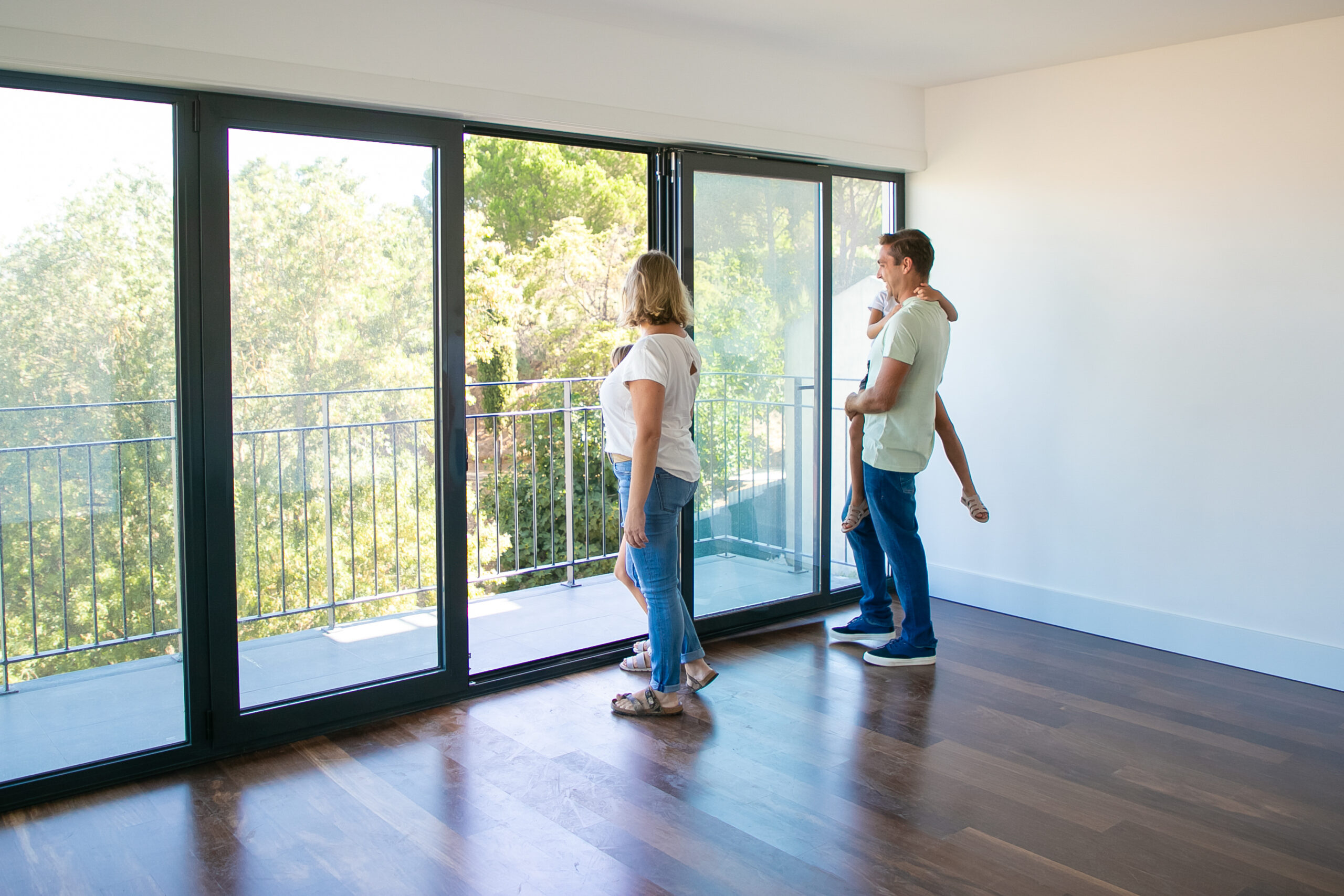 An image of a family of three checking out the safety of their sliding door.